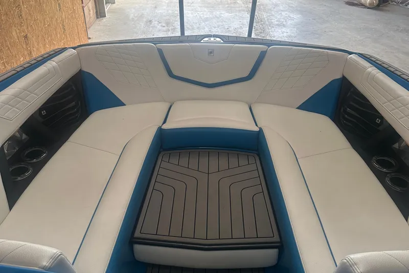 Slide: The Image of 2021 Nautique Super Air Nautique G25 interior with white and blue seating. - 5