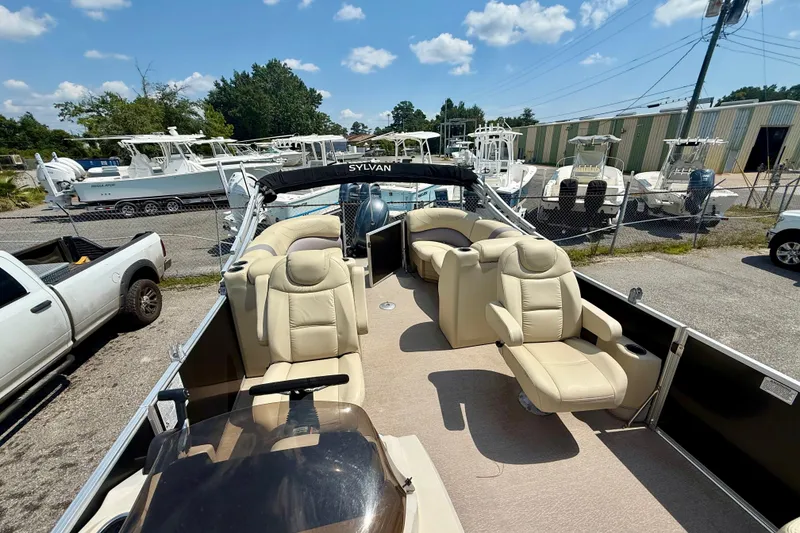 Slide: The Image of 2018 Sylvan Mirage Cruise 8522 LZ pontoon boat with beige seating, parked outdoors. - 6