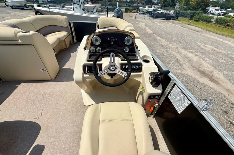 Slide: The Image of 2018 Sylvan Mirage Cruise 8522 LZ boat interior with steering wheel and seating. - 7