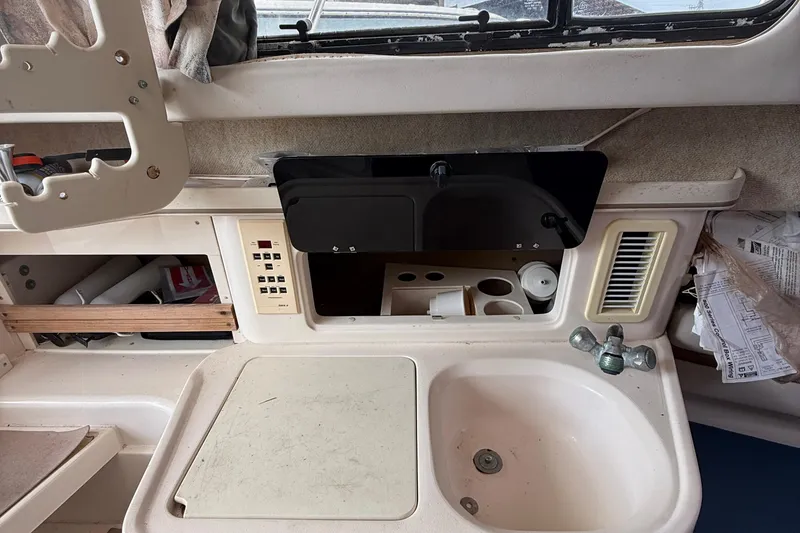 Slide: The Image of 2001 Grady-White Marlin 300 boat interior with sink and storage compartments. - 10