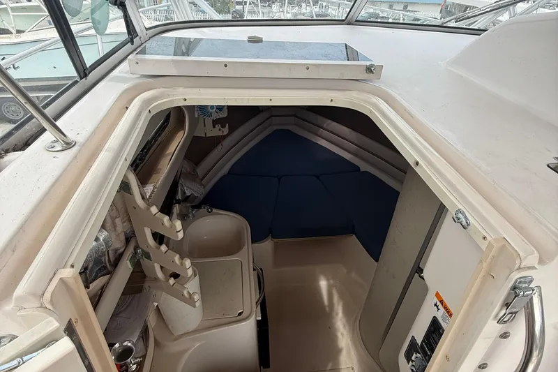 Slide: The Image of 2001 Grady-White Marlin 300 cabin interior with blue cushions and compact amenities. - 12