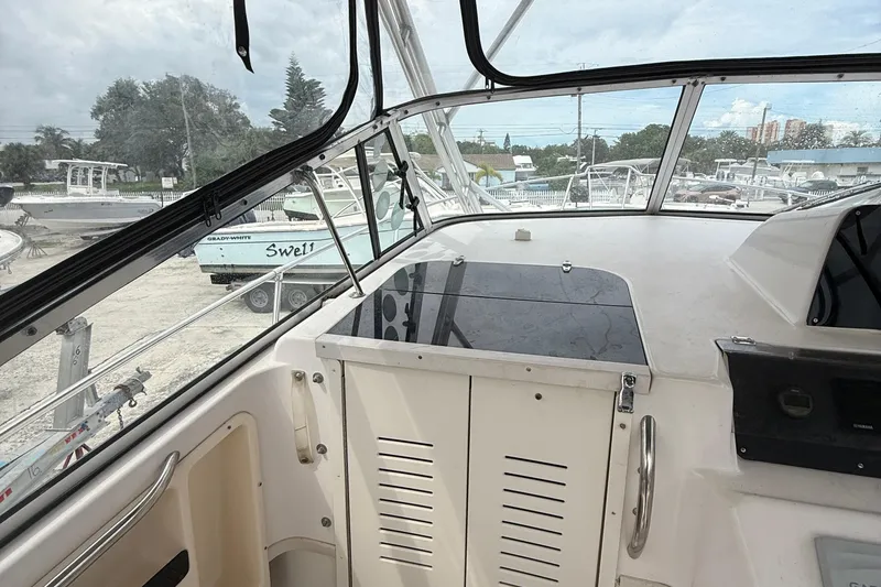 Slide: The Image of 2001 Grady-White Marlin 300 boat interior with view of marina and other boats. - 13