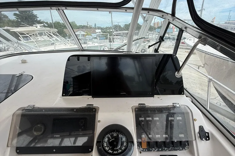 Slide: The Image of 2001 Grady-White Marlin 300 boat dashboard with navigation instruments and controls. - 16