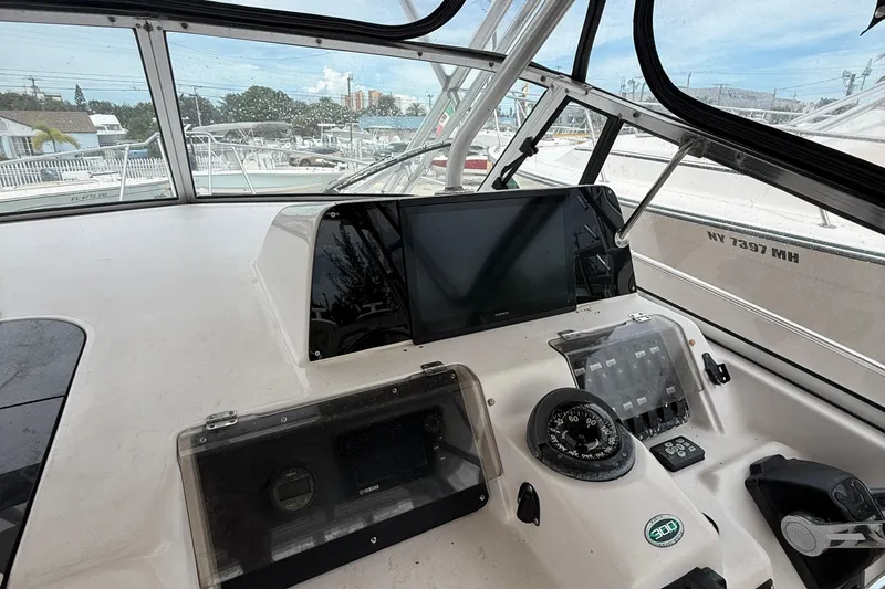 Slide: The Image of 2001 Grady-White Marlin 300 boat dashboard with navigation instruments and compass. - 18
