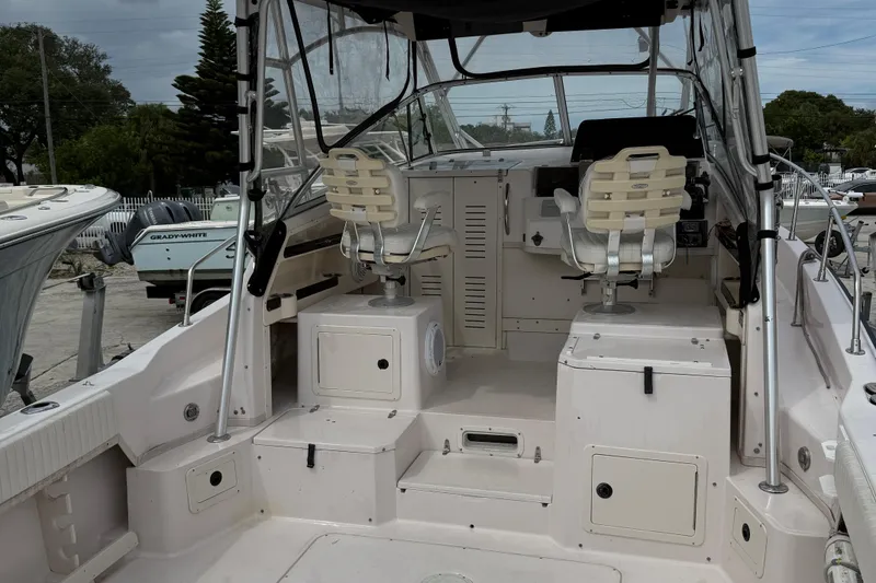 Slide: The Image of 2001 Grady-White Marlin 300 boat interior with dual captain chairs and control panel. - 28