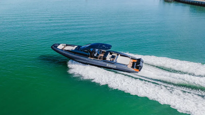 Slide: The Image of 2023 Pirelli Tecnorib 50 speedboat cruising on clear turquoise water. - 10