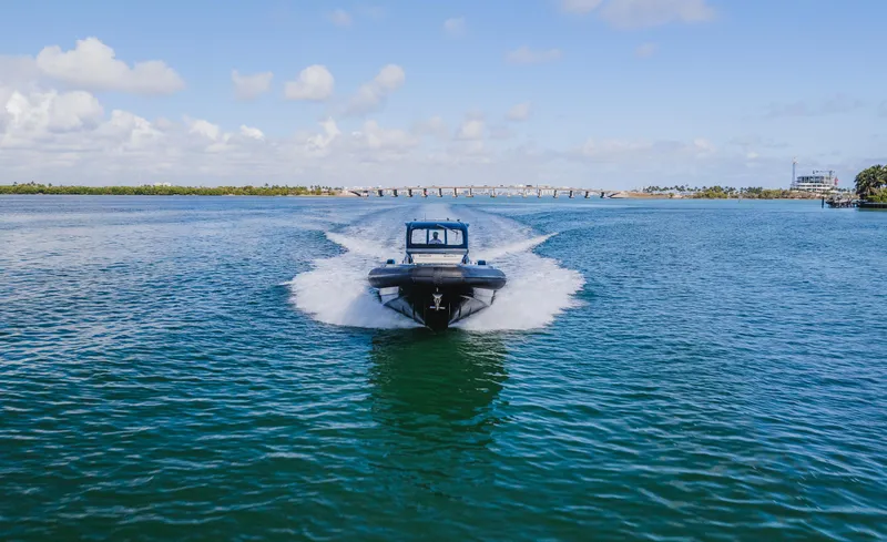 Slide: The Image of 2023 Pirelli Tecnorib 50 cruising on open water under a clear blue sky. - 11