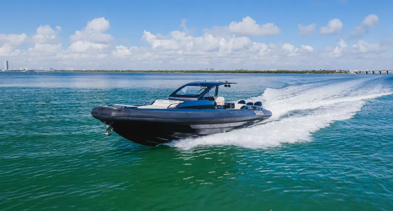 Slide: The Image of 2023 Pirelli Tecnorib 50 speedboat cruising on clear blue water. - 12