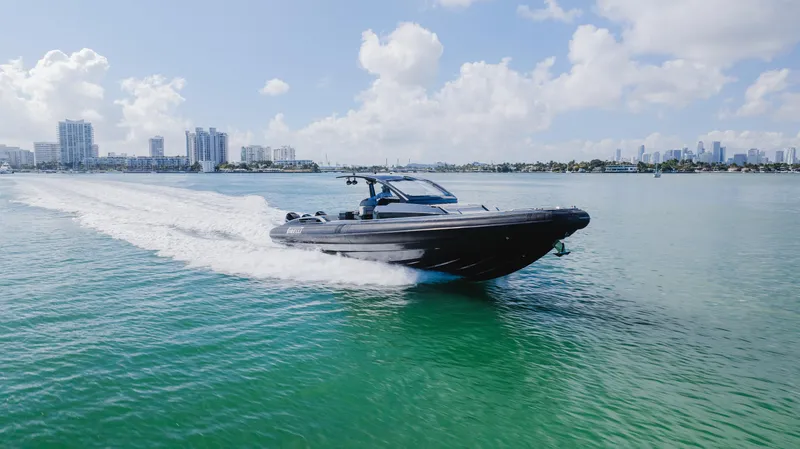 Slide: The Image of 2023 Pirelli Tecnorib 50 speedboat cruising on clear blue water under a sunny sky. - 24
