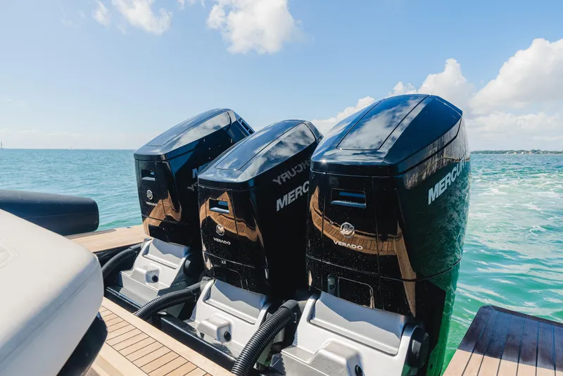 Slide: The Image of Triple Mercury outboard engines on 2023 Pirelli Tecnorib 50, cruising on clear blue water. - 25