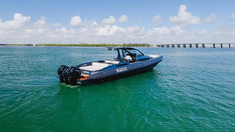 Slide: The Image of 2023 Pirelli Tecnorib 50 boat on clear blue water, bridge in background. - 30