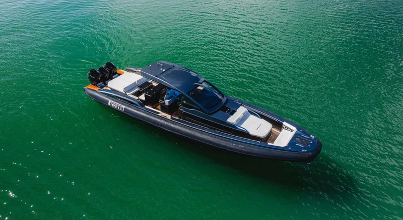 Slide: The Image of 2023 Pirelli Tecnorib 50 luxury boat on clear green water. - 32