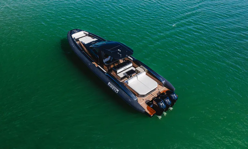 Slide: The Image of 2023 Pirelli Tecnorib 50 luxury boat on calm green water. - 35