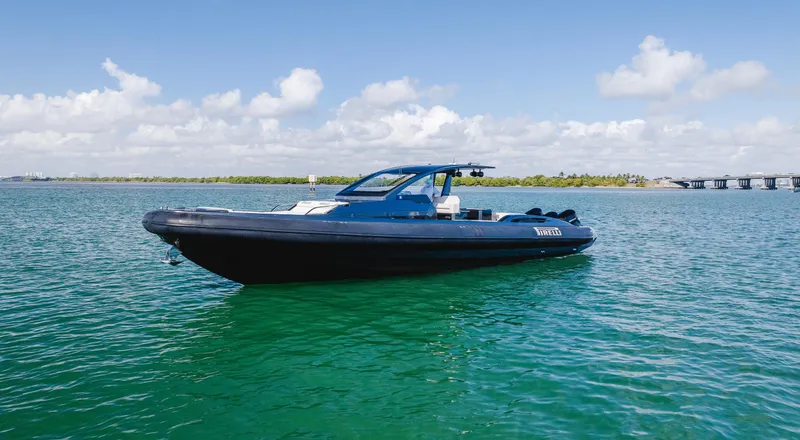 Slide: The Image of 2023 Pirelli Tecnorib 50 boat on calm water under blue sky. - 36