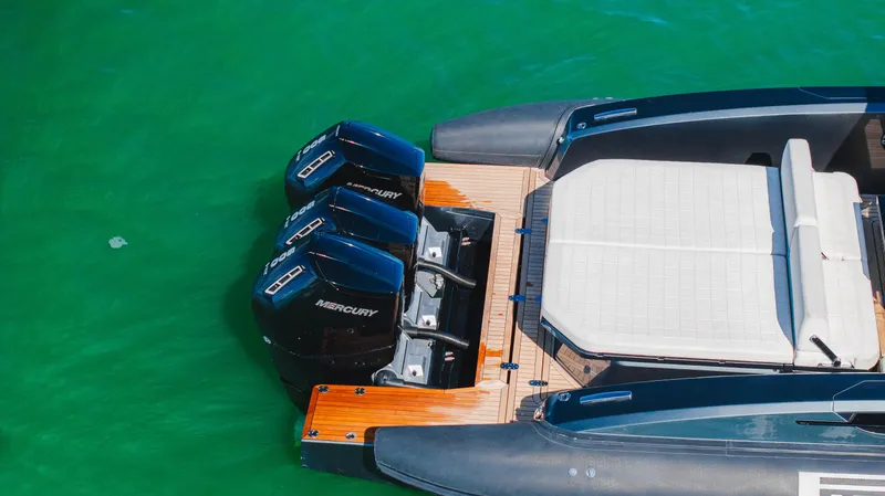 Slide: The Image of 2023 Pirelli Tecnorib 50 boat with triple Mercury engines on green water. - 38