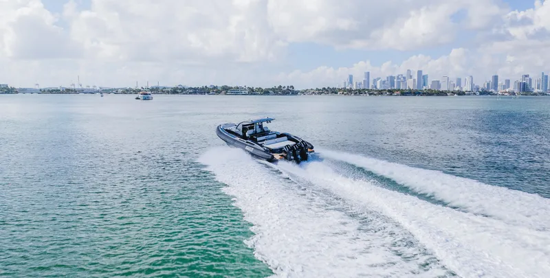 Slide: The Image of 2023 Pirelli Tecnorib 50 speeding on open water with city skyline in background. - 5