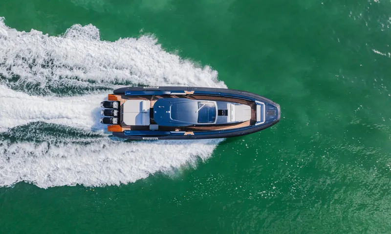 Slide: The Image of Aerial view of 2023 Pirelli Tecnorib 50 speedboat cruising on green water. - 8