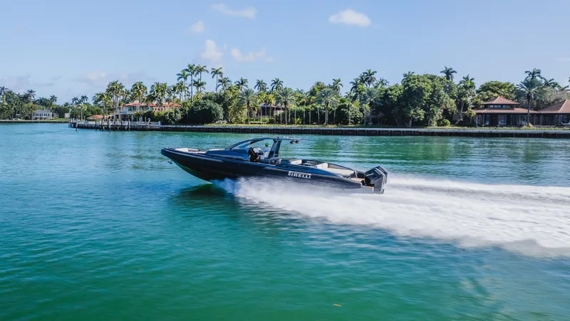 Slide: The Image of 2023 Pirelli Tecnorib 50 speedboat cruising on a tropical waterway. - 9