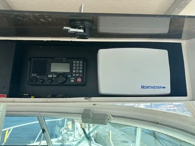 Slide: The Image of 1987 Shamrock 31 GS boat dashboard with radio and Northstar navigation system. - 11