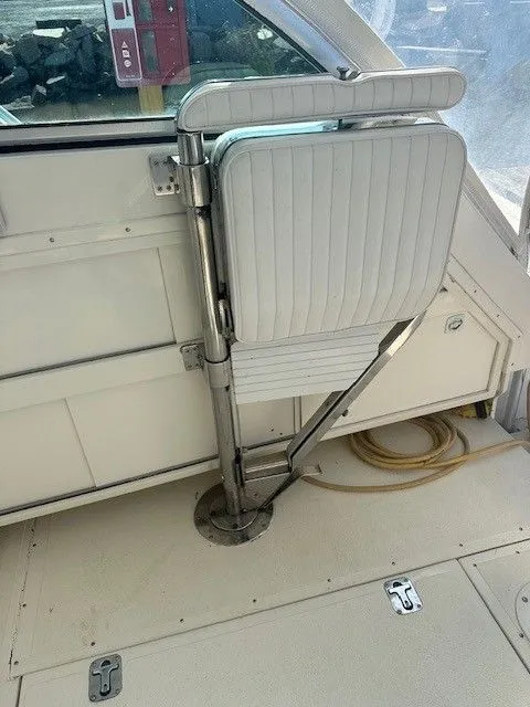 Slide: The Image of 1987 Shamrock 31 GS boat interior with foldable seat and metal support. - 13