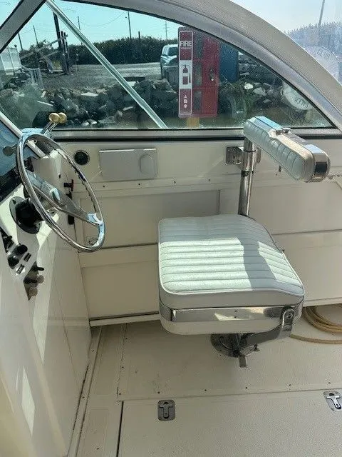 Slide: The Image of 1987 Shamrock 31 GS boat interior with white captain's chair and steering wheel. - 14