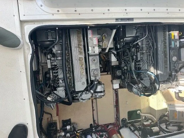 Slide: The Image of Engine compartment of a 1987 Shamrock 31 GS boat, showcasing dual engines and mechanical components. - 15