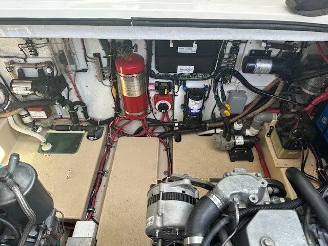 Slide: The Image of Engine room of a 1987 Shamrock 31 GS boat, featuring various mechanical components and wiring. - 18