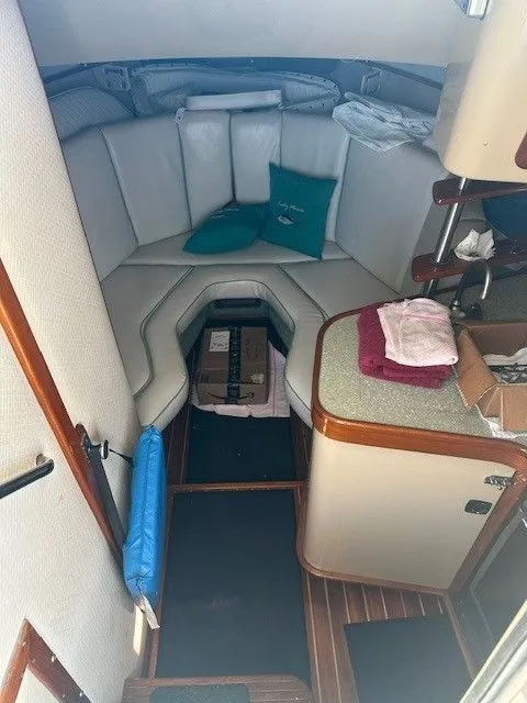 Slide: The Image of 1987 Shamrock 31 GS cabin interior with seating, cushions, and storage boxes. - 20