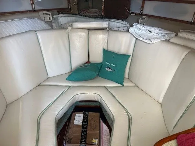 Slide: The Image of 1987 Shamrock 31 GS boat interior with white seating and teal cushions. - 22