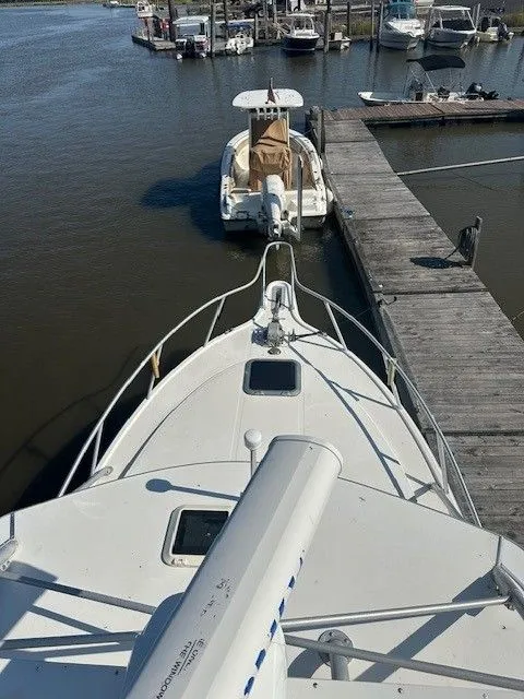 Slide: The Image of 1987 Shamrock 31 GS boat docked at marina, view from bow. - 26