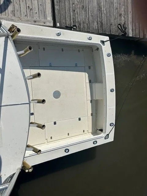 Slide: The Image of 1987 Shamrock 31 GS boat docked, aerial view of spacious deck and fishing rod holders. - 27