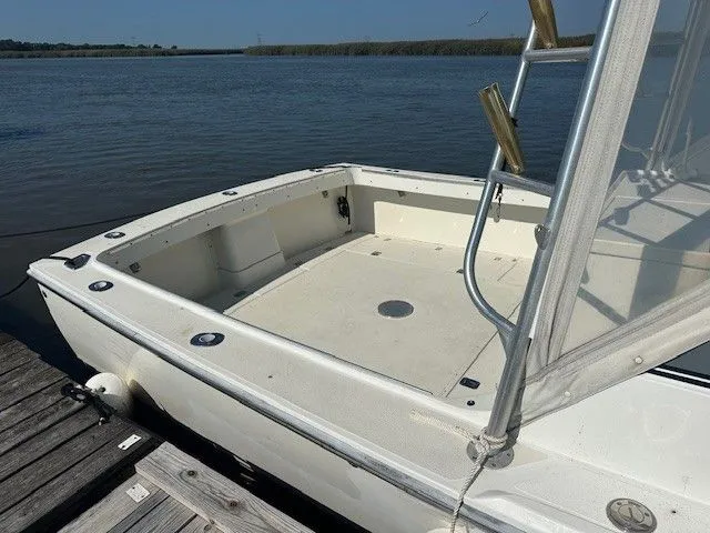 Slide: The Image of 1987 Shamrock 31 GS boat docked by the water, showcasing spacious deck area. - 30