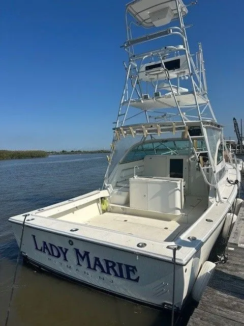 Slide: The Image of 1987 Shamrock 31 GS boat docked, featuring a tall tower and "Lady Marie" name on the stern. - 5