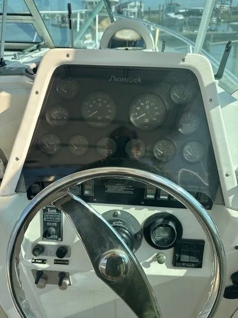 Slide: The Image of Control panel of a 1987 Shamrock 31 GS boat with steering wheel and gauges. - 8