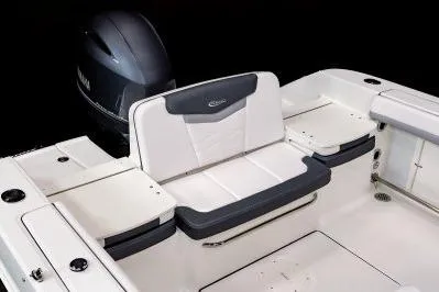 Slide: The Image of 2026 Robalo R207 Dual Console boat storage compartment with latch, open view. - 11