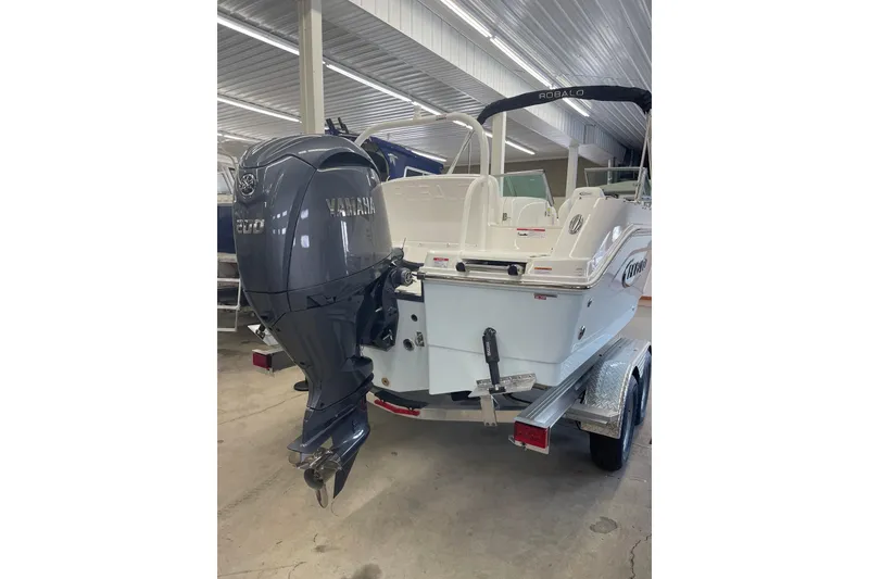 Slide: The Image of 2026 Robalo R207 Dual Console boat with Yamaha engine in showroom. - 13