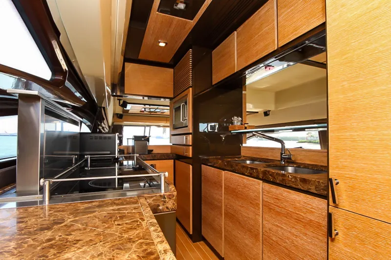 Slide: The Image of Luxurious kitchen interior of 2011 Azimut 70 yacht with modern wood cabinetry and marble countertops. - 14
