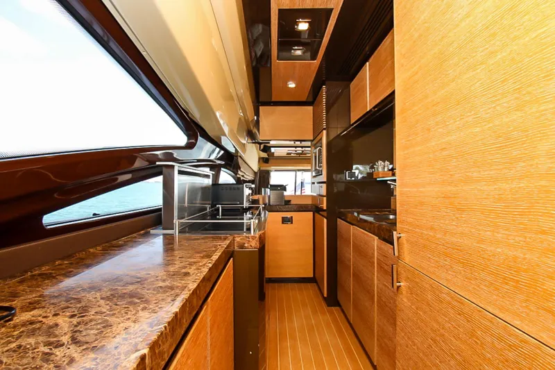 Slide: The Image of Luxurious interior of a 2011 Azimut 70 yacht, featuring elegant wood finishes and modern design. - 15