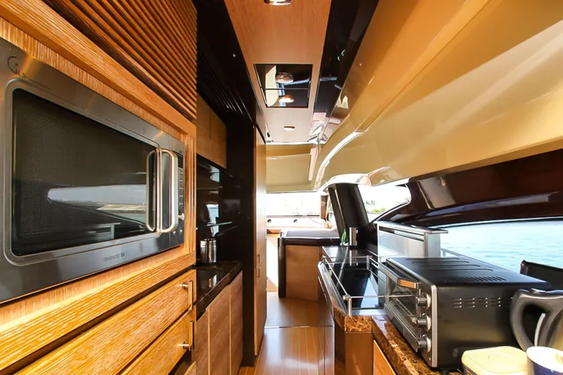 Slide: The Image of Luxurious kitchen interior of 2011 Azimut 70 yacht with modern appliances and wood finishes. - 16