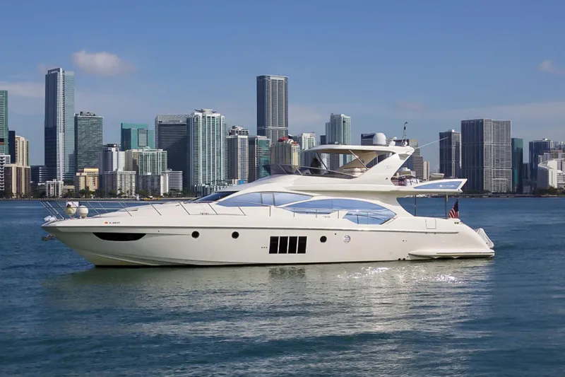 Slide: The Image of Luxury 2011 Azimut 70 yacht cruising near city skyline. - 2