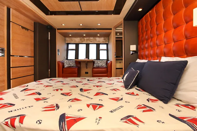 Slide: The Image of Luxurious bedroom interior of 2011 Azimut 70 yacht with nautical-themed bedding and elegant decor. - 22