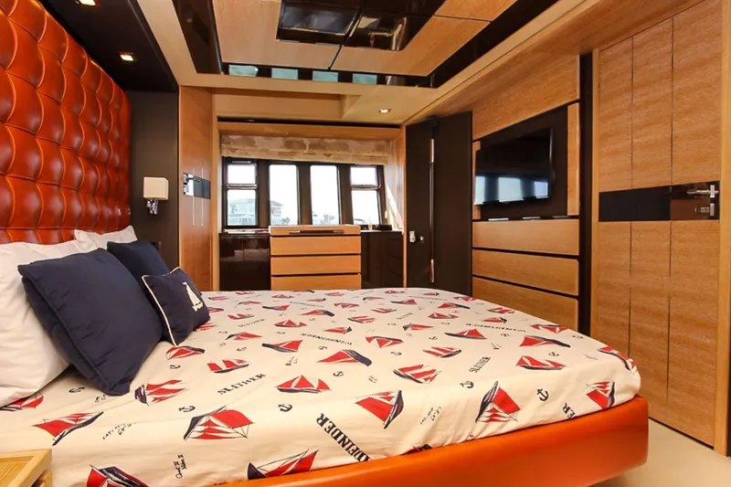 Slide: The Image of Luxurious bedroom interior of 2011 Azimut 70 yacht with modern design and nautical-themed bedding. - 23