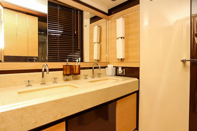 Slide: The Image of Luxurious bathroom interior on a 2011 Azimut 70 yacht, featuring dual sinks and modern fixtures. - 26
