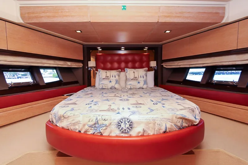 Slide: The Image of Luxurious bedroom interior of 2011 Azimut 70 yacht with round bed and nautical-themed decor. - 28