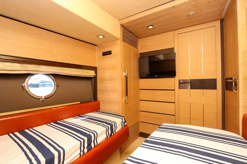 Slide: The Image of Interior of 2011 Azimut 70 yacht cabin with twin beds and porthole window. - 33