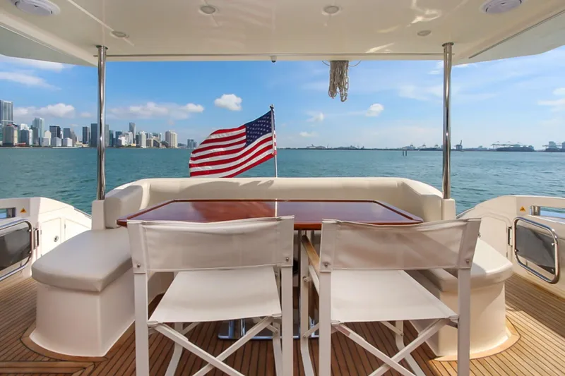 Slide: The Image of Luxury Azimut 70 yacht deck with American flag, city skyline view, 2011 model. - 39