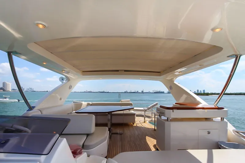 Slide: The Image of Luxurious 2011 Azimut 70 yacht deck with seating, table, and ocean view. - 43