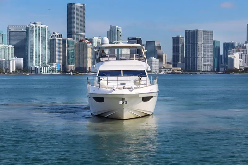 Slide: The Image of Azimut 70 yacht (2011) cruising near a city skyline on a sunny day. - 6