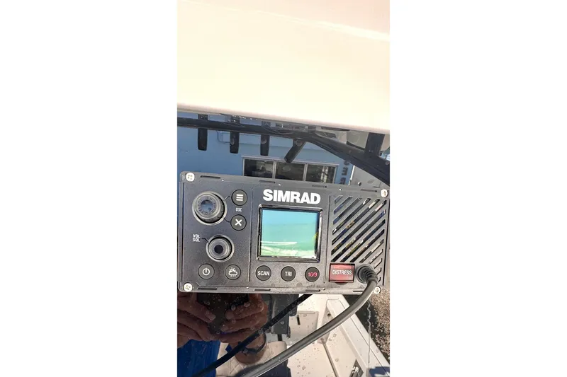Slide: The Image of Simrad marine radio on 2024 Sea Pro 242 boat dashboard. - 14