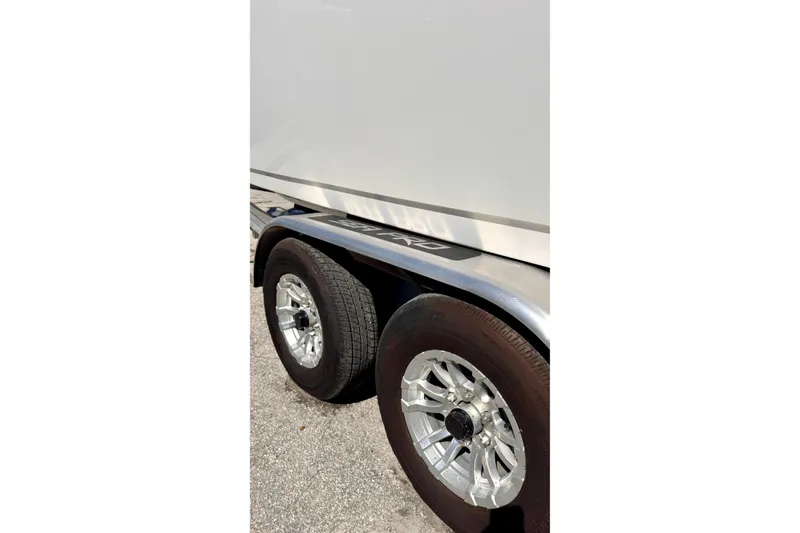 Slide: The Image of 2024 Sea Pro 242 boat trailer with dual wheels and sleek design. - 19